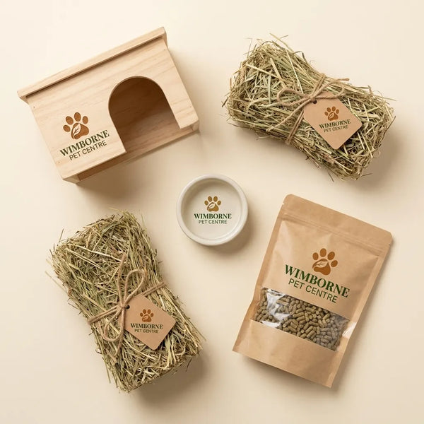 Wimborne Pet Centre products including a wooden pet house, hay, and pet food on a light background.